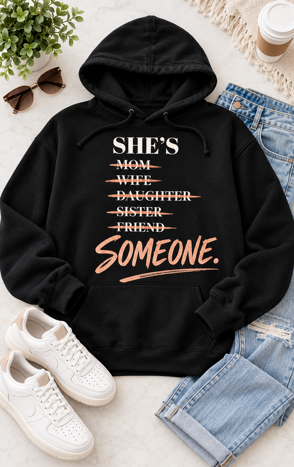 Black She’s Someone women’s graphic statement hoodie flat lay